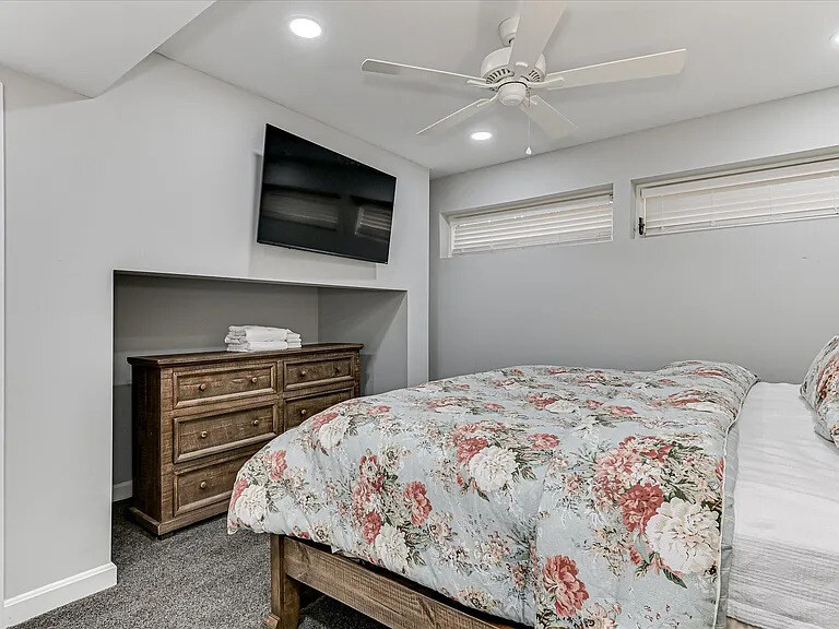 An Azalea bedroom with a patterned duvet and a glazed door opening to the outdoors