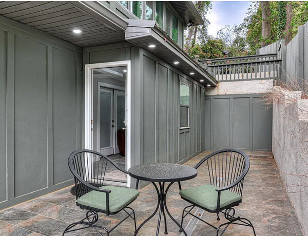The private slate patio outside The Azalea apartment with patio seating