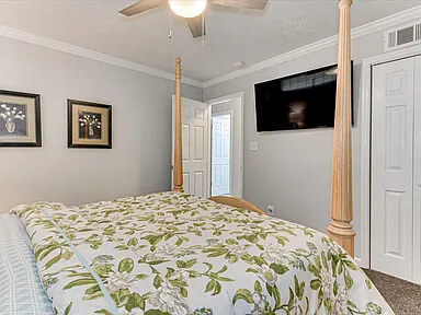 The second Dogwood bedroom with a timber four-poster bed, dresser, and mirror
