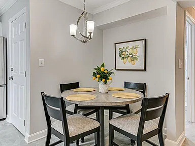 A quiet corner of The Dogwood with a leather chair, console table, and lamp
