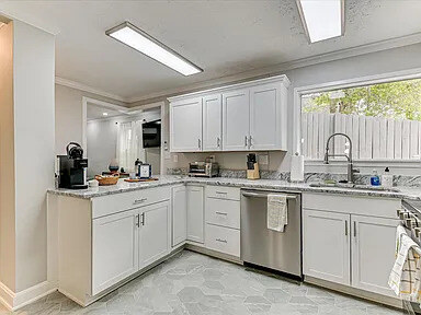 Looking down the Dogwood's hall past the granite kitchen counter toward the entry