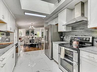 The Magnolia's long kitchen island and range under marble-tiled floors