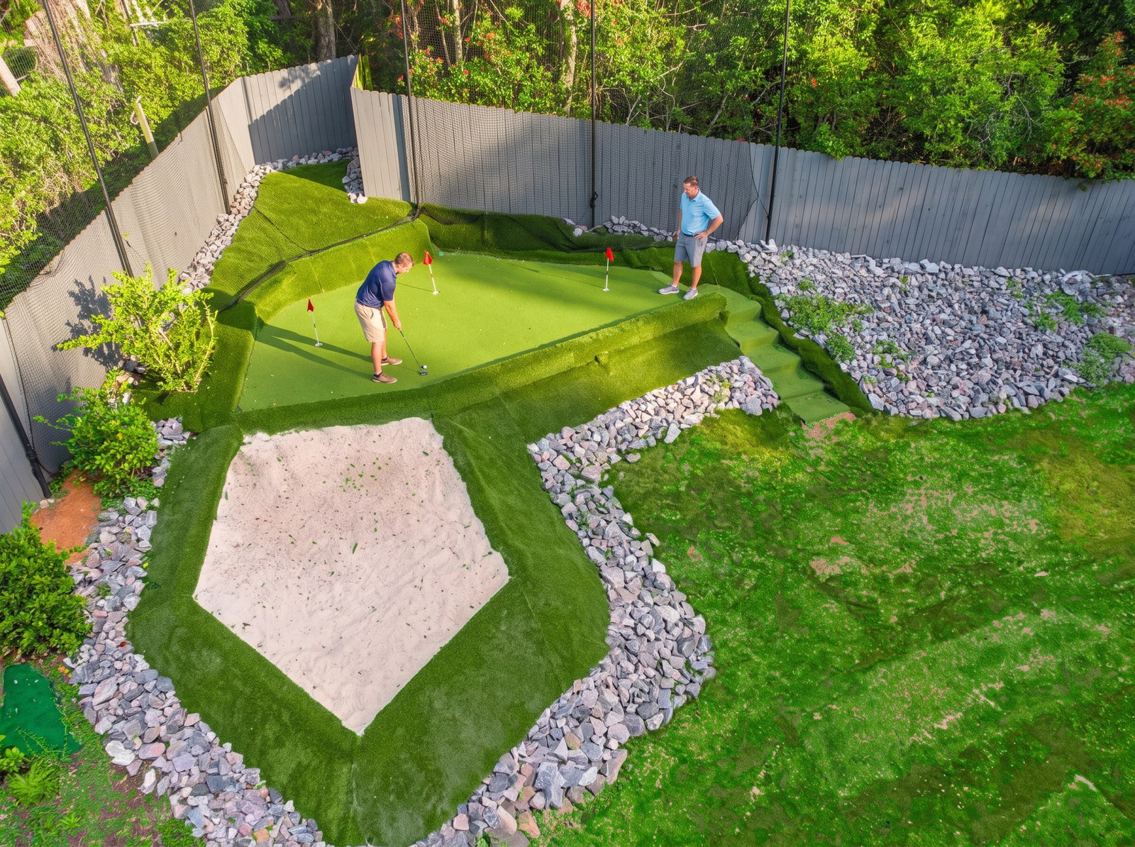 Aerial view of the private putting green and practice bunker at The Wilkshire House with red pin flags in place